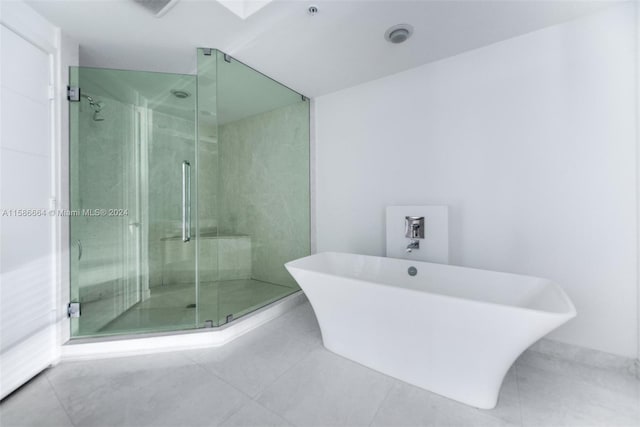 bathroom featuring tile floors and a shower with shower door