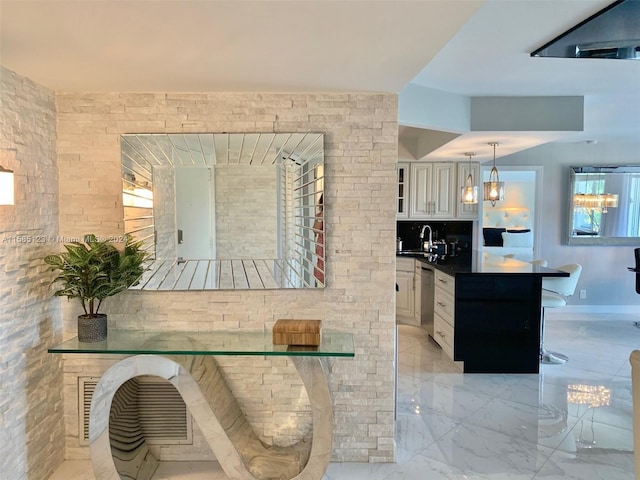 kitchen featuring white cabinetry, a chandelier, stainless steel dishwasher, and light tile floors