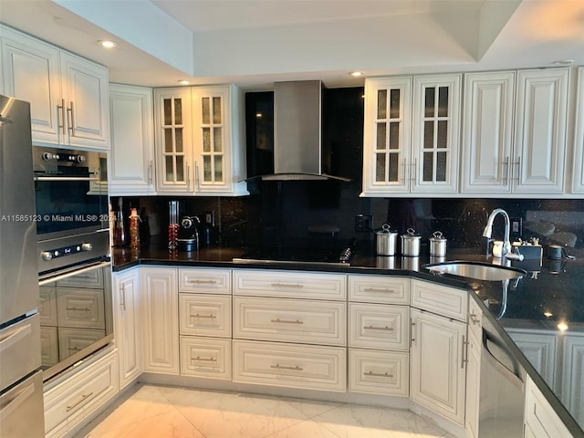 kitchen with black appliances, backsplash, light tile floors, wall chimney exhaust hood, and sink