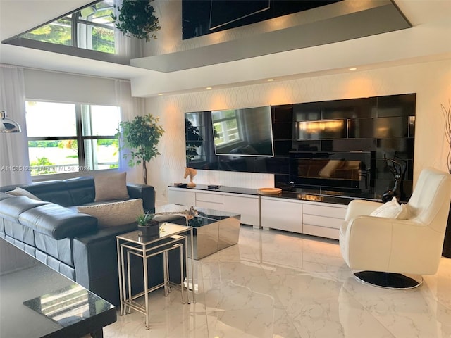 tiled living room with a high ceiling and plenty of natural light