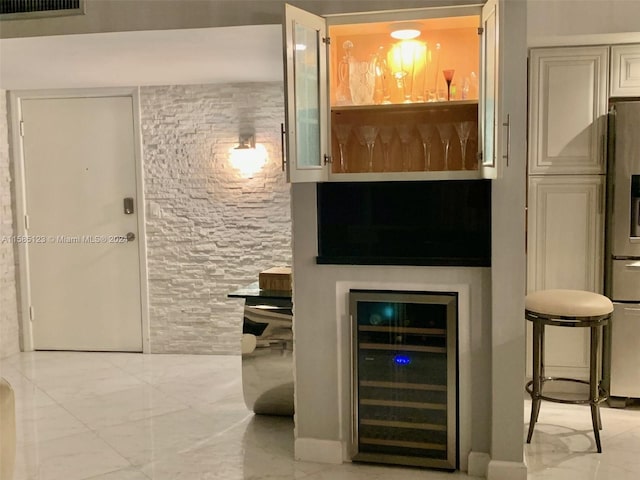 bar featuring wine cooler, stainless steel fridge with ice dispenser, and light tile flooring