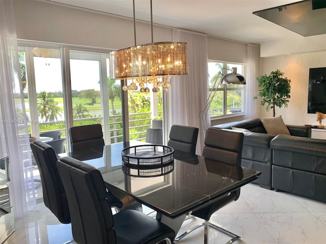 dining room with a notable chandelier and light tile floors