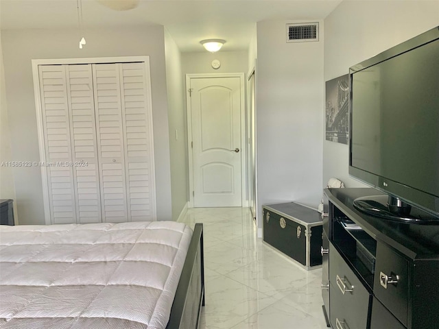 tiled bedroom featuring a closet