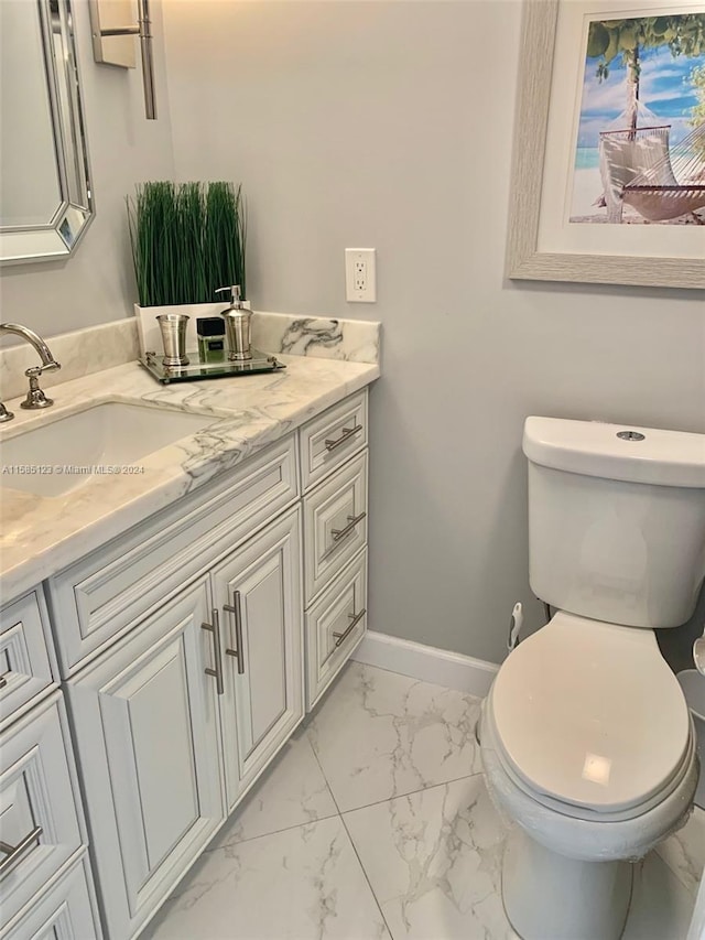 bathroom with tile flooring, toilet, and vanity