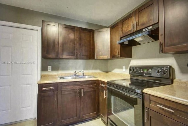 kitchen featuring dark brown cabinets, sink, and black electric range