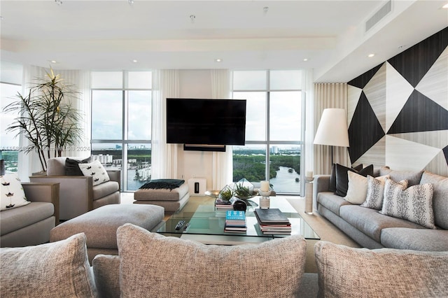 living room featuring a healthy amount of sunlight and expansive windows