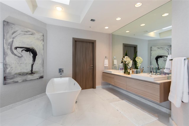 bathroom featuring tile floors, dual bowl vanity, a raised ceiling, and a bathing tub