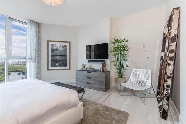 bedroom featuring light wood-type flooring and multiple windows