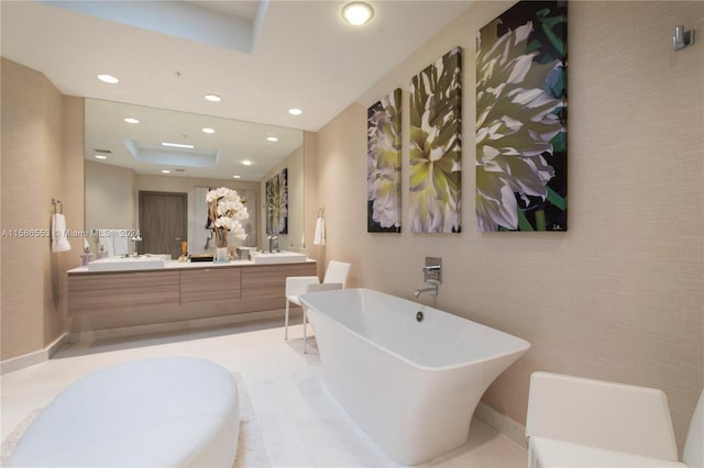 bathroom with a washtub, tile flooring, and double vanity