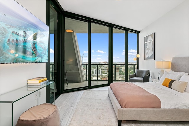 bedroom featuring a wall of windows and access to exterior