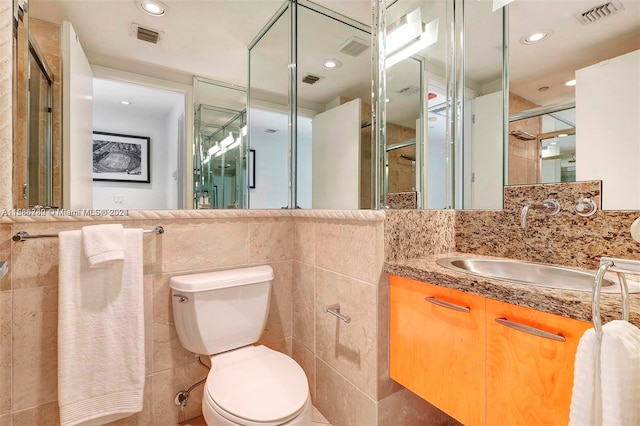 bathroom featuring oversized vanity, an enclosed shower, tile walls, backsplash, and toilet