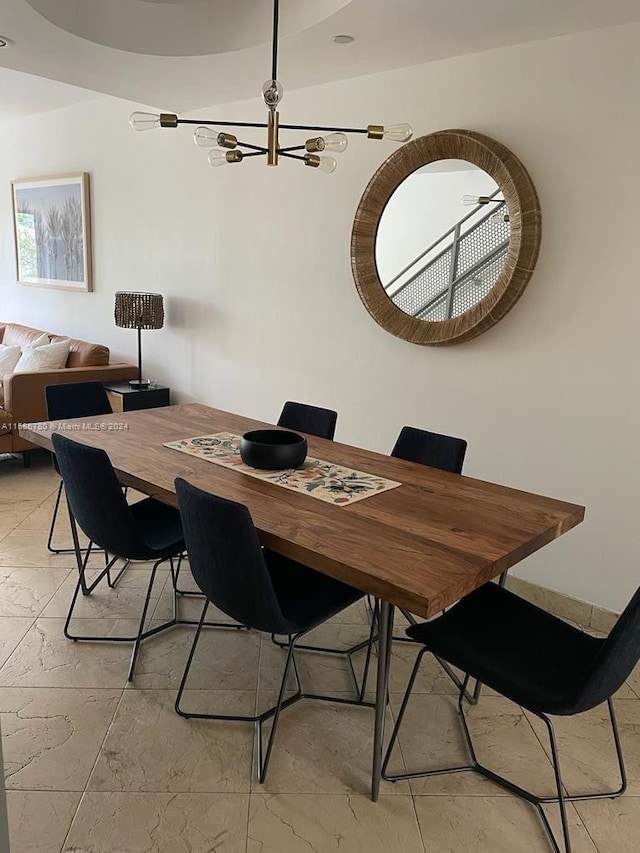 dining area with a chandelier and light tile floors