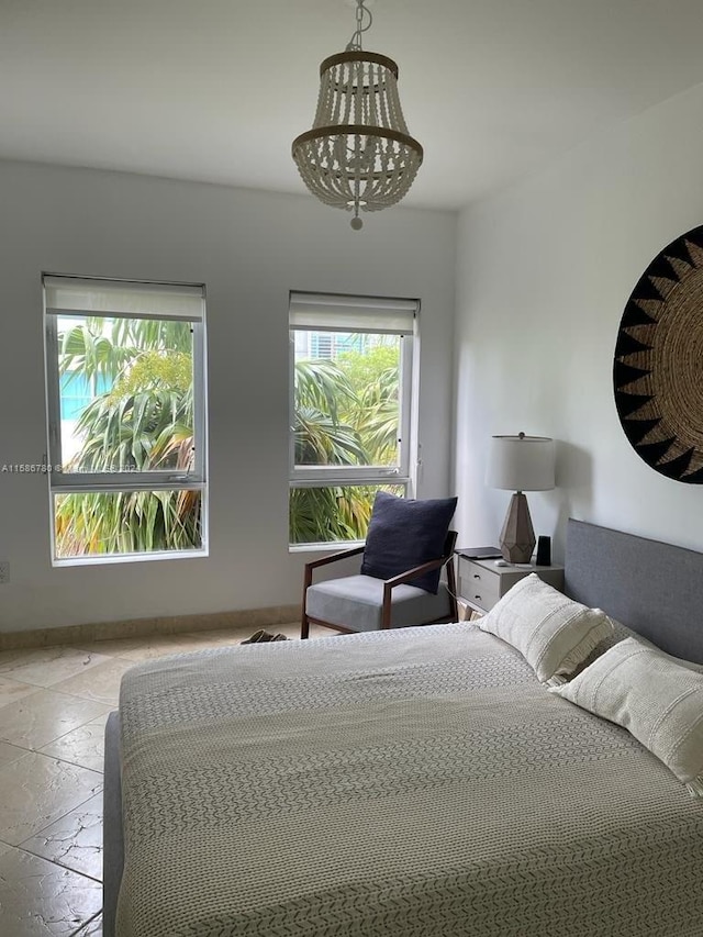 bedroom featuring tile floors and an inviting chandelier