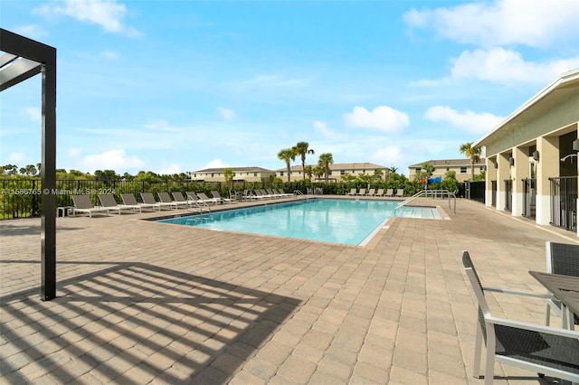 view of swimming pool with a patio