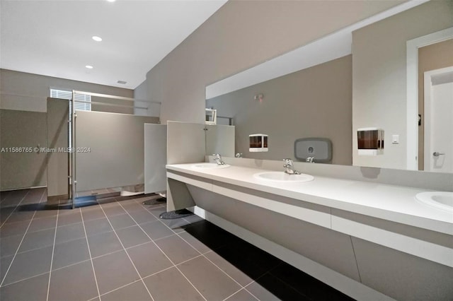 bathroom featuring walk in shower, vanity, and tile patterned flooring