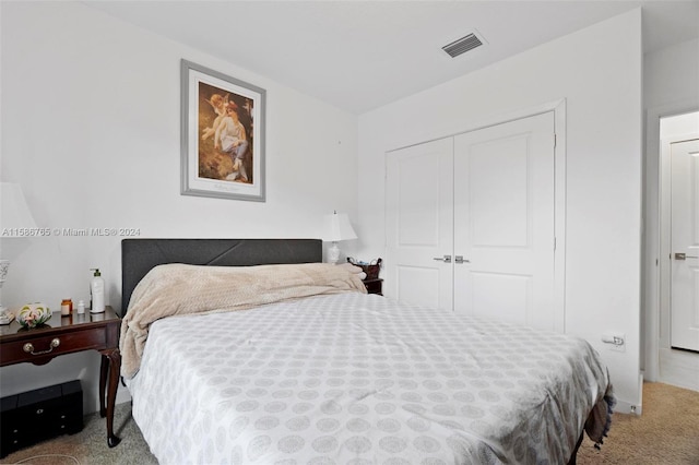 carpeted bedroom with a closet