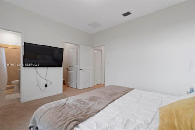 carpeted bedroom featuring ensuite bathroom