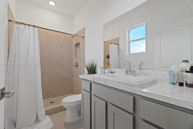 bathroom featuring curtained shower, vanity, and toilet