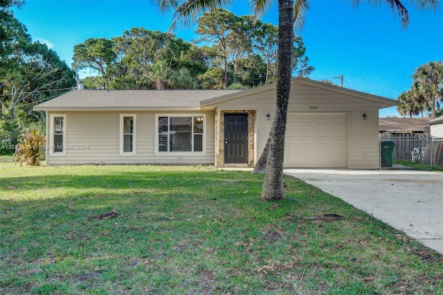 ranch-style house featuring a front lawn and a garage