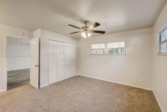 unfurnished bedroom with carpet, ceiling fan, and multiple windows