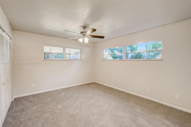 unfurnished bedroom with carpet, a closet, and ceiling fan