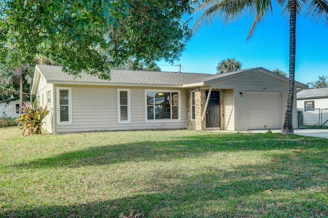 ranch-style home with a garage and a front lawn