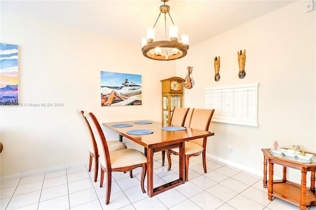 dining area featuring a notable chandelier and light tile floors