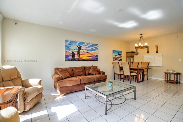 living room with a chandelier and light tile floors