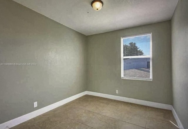 spare room with tile floors