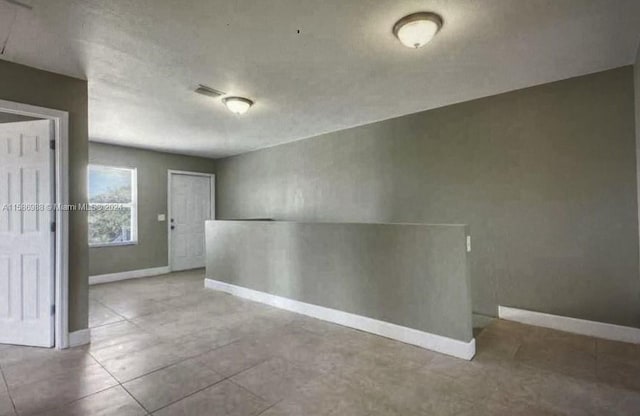 unfurnished room featuring tile floors