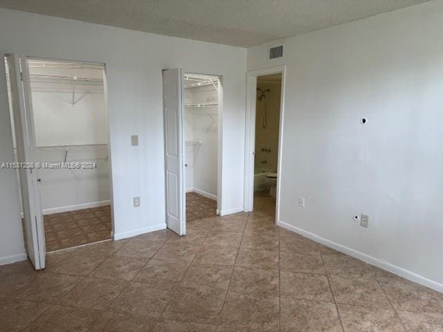 unfurnished bedroom with a textured ceiling