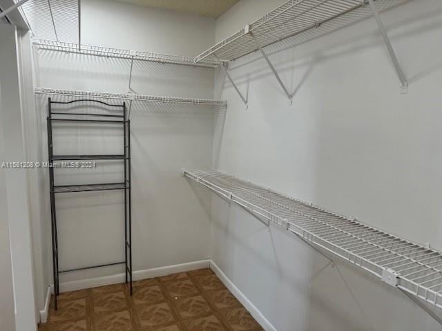 spacious closet with parquet floors