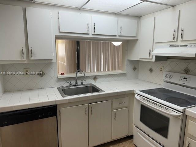 kitchen featuring tasteful backsplash, sink, electric range, dishwasher, and white cabinetry