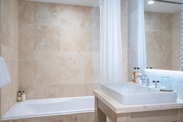 bathroom featuring tile walls and vanity