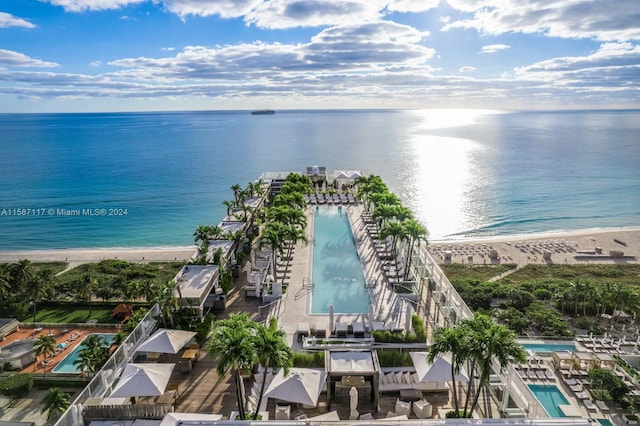 birds eye view of property featuring a view of the beach and a water view