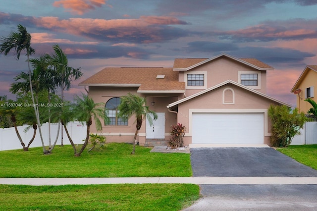 view of front of house with a yard and a garage