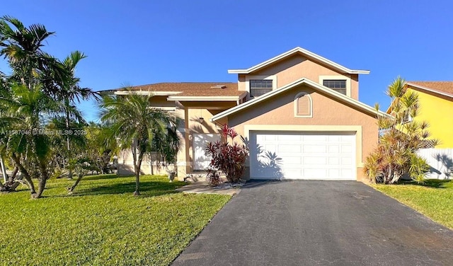 view of front of house with a front yard and a garage