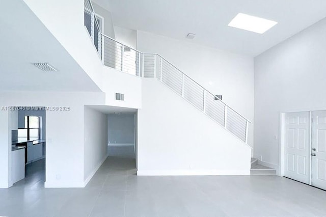 stairs featuring a towering ceiling