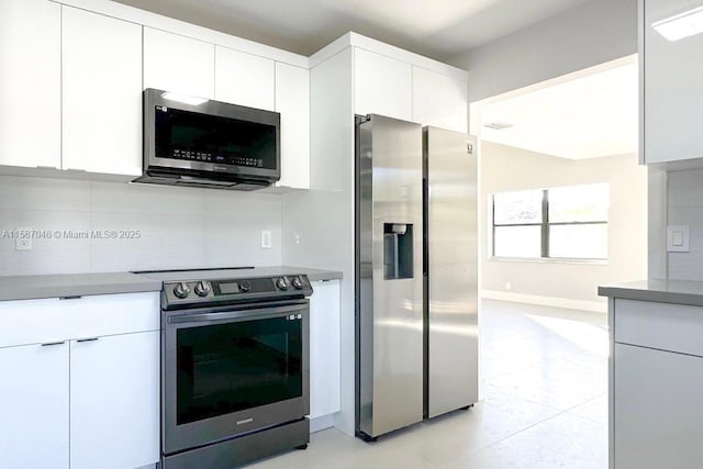 kitchen featuring backsplash, white cabinetry, and stainless steel appliances