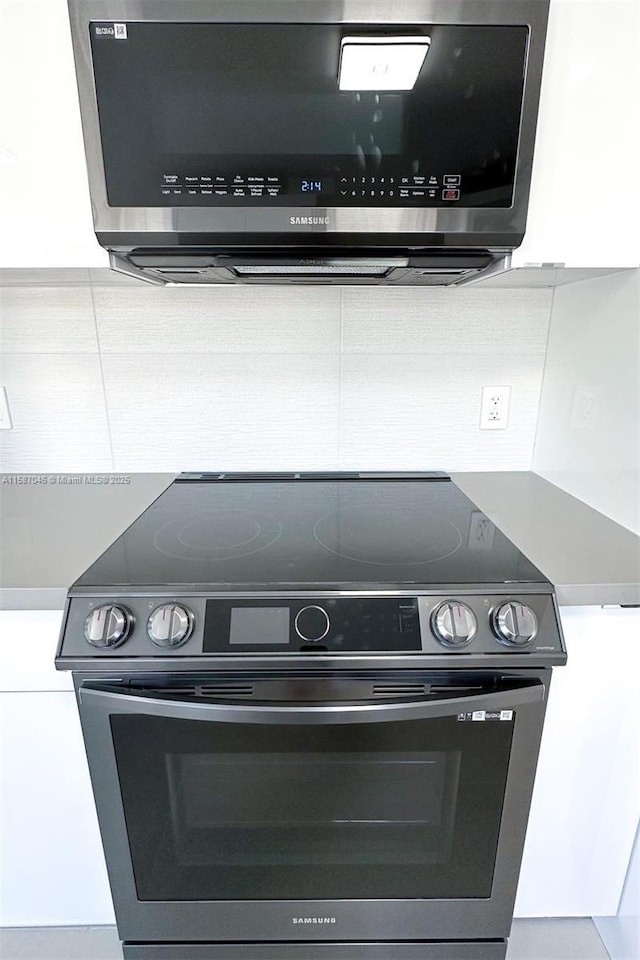 room details featuring white cabinetry and stainless steel appliances