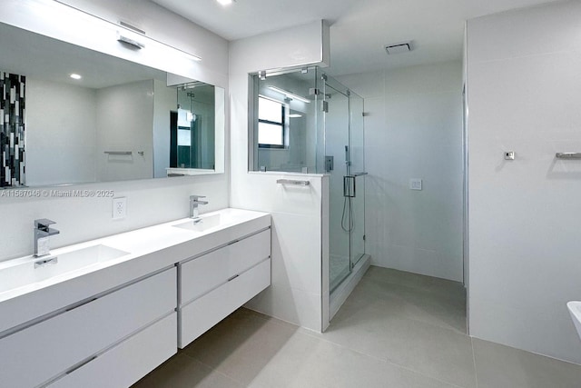 bathroom featuring tile patterned flooring, vanity, and a shower with shower door