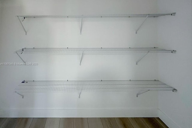 walk in closet featuring dark hardwood / wood-style flooring