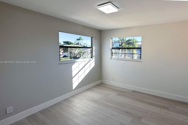 unfurnished room featuring light hardwood / wood-style floors