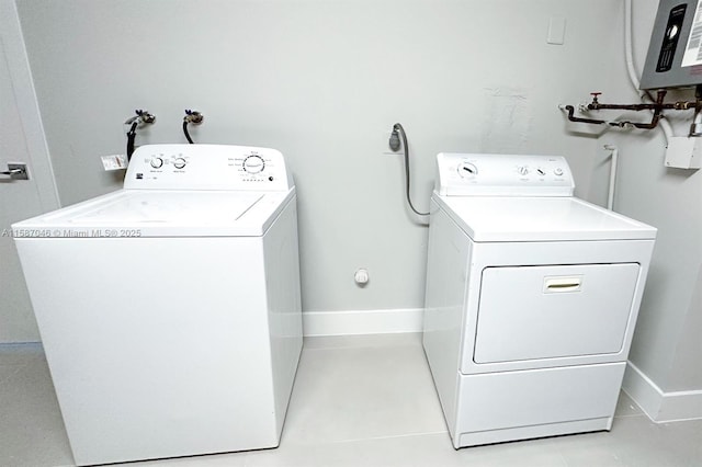 laundry area featuring separate washer and dryer and water heater