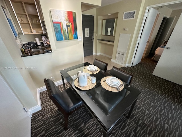 dining room featuring dark carpet