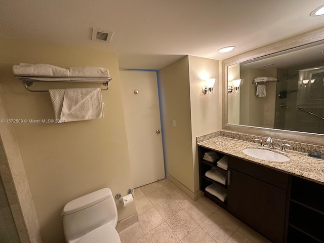 bathroom with vanity, toilet, and a shower with door