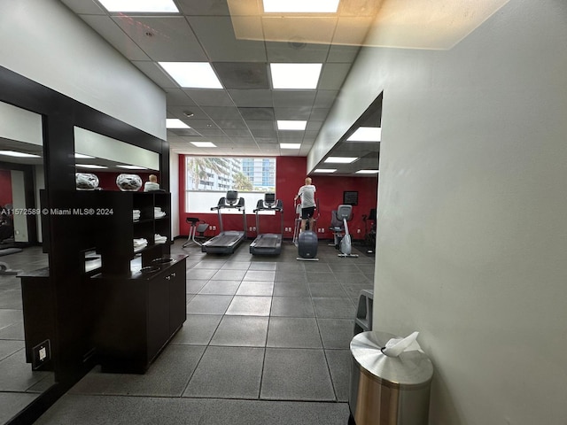 gym with a paneled ceiling