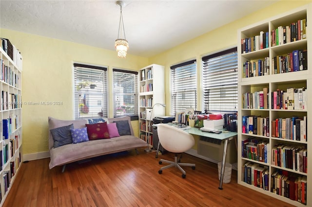 home office with baseboards and wood finished floors