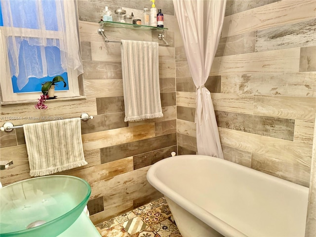 full bathroom featuring a sink and a freestanding tub