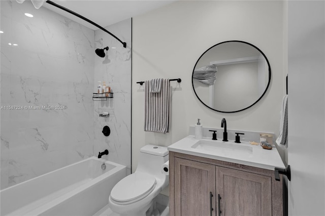 full bathroom with vanity, tiled shower / bath combo, and toilet